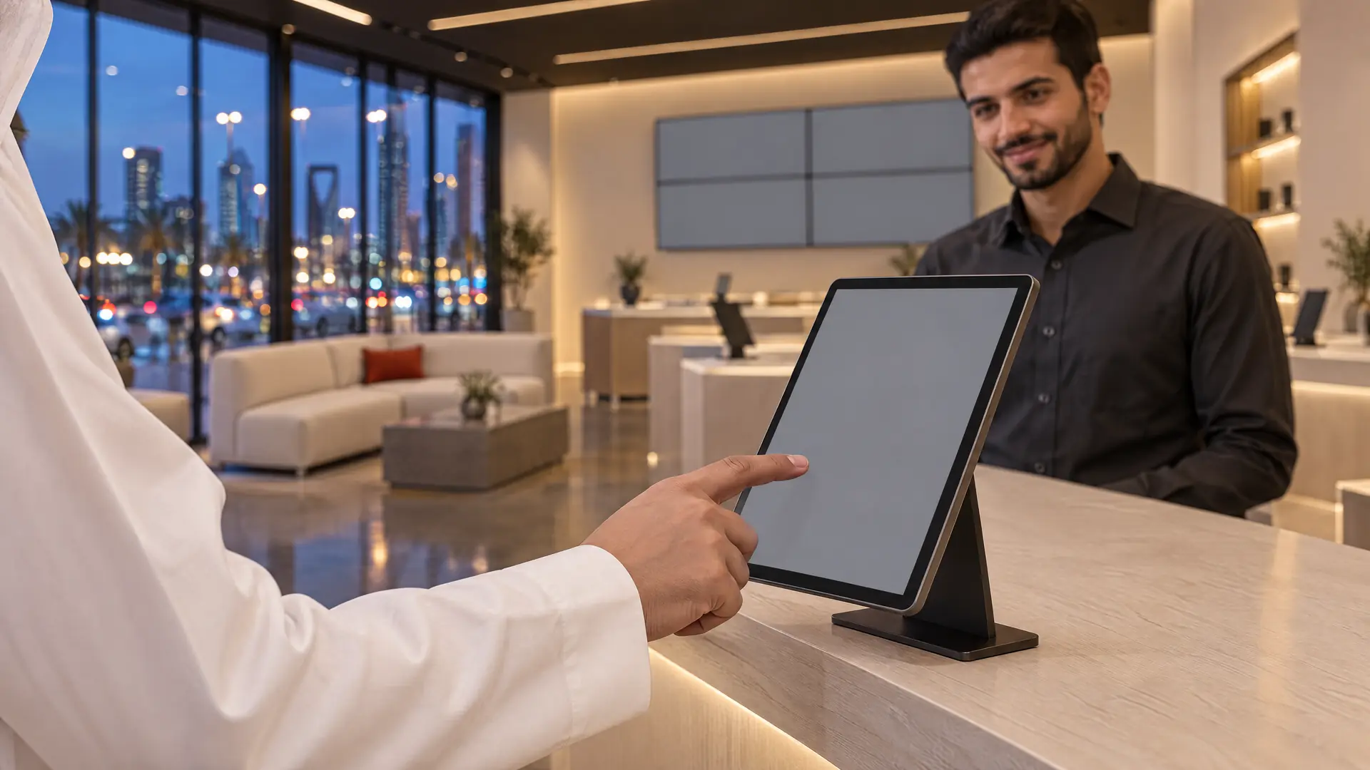 A customer taps a tablet on the service counter while the advisor smiles behind it